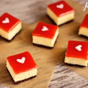 white chocolate cheesecake squares with strawberry glaze