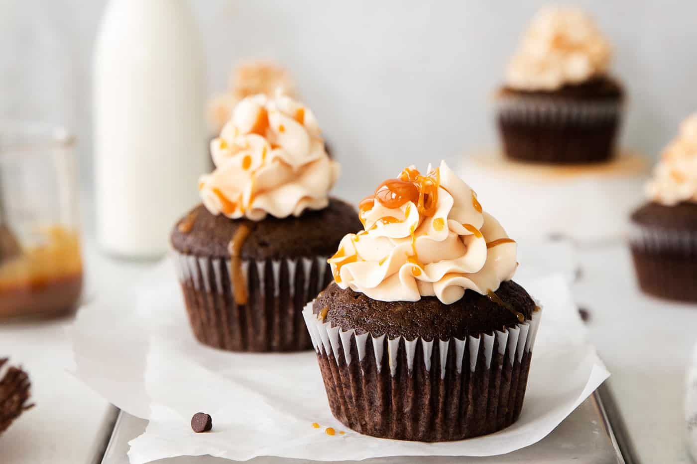 Three chocolate cupcakes frosted and topped with caramel