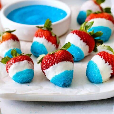 White chocolate covered strawberries dipped in blue sugar
