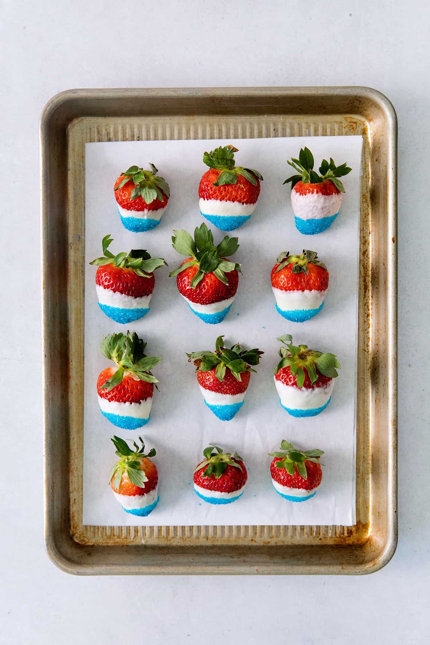 4th of july chocolate covered strawberries on a sheet pan