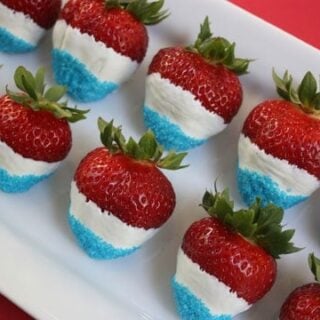 strawberries dipped in white chocolate with blue sprinkles