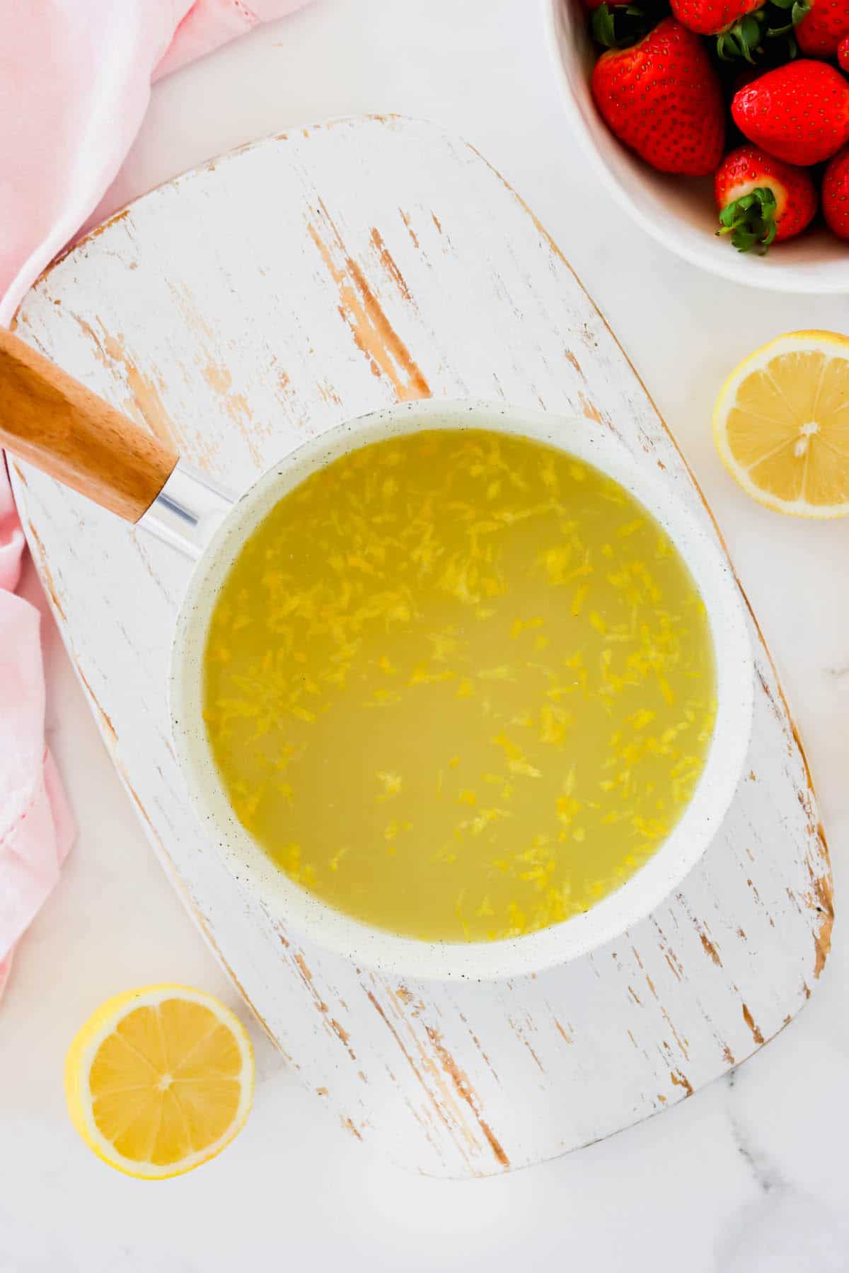 A pan of sugar water and lemon zest and juice