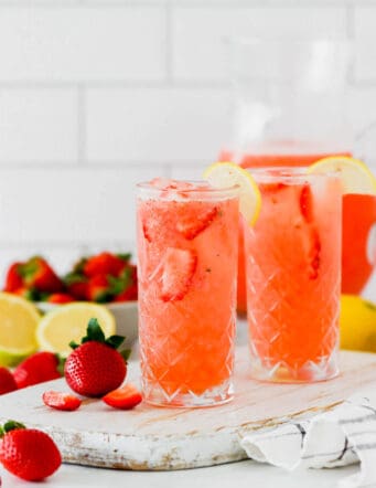 Two glasses of fresh lemonade with strawberry slices