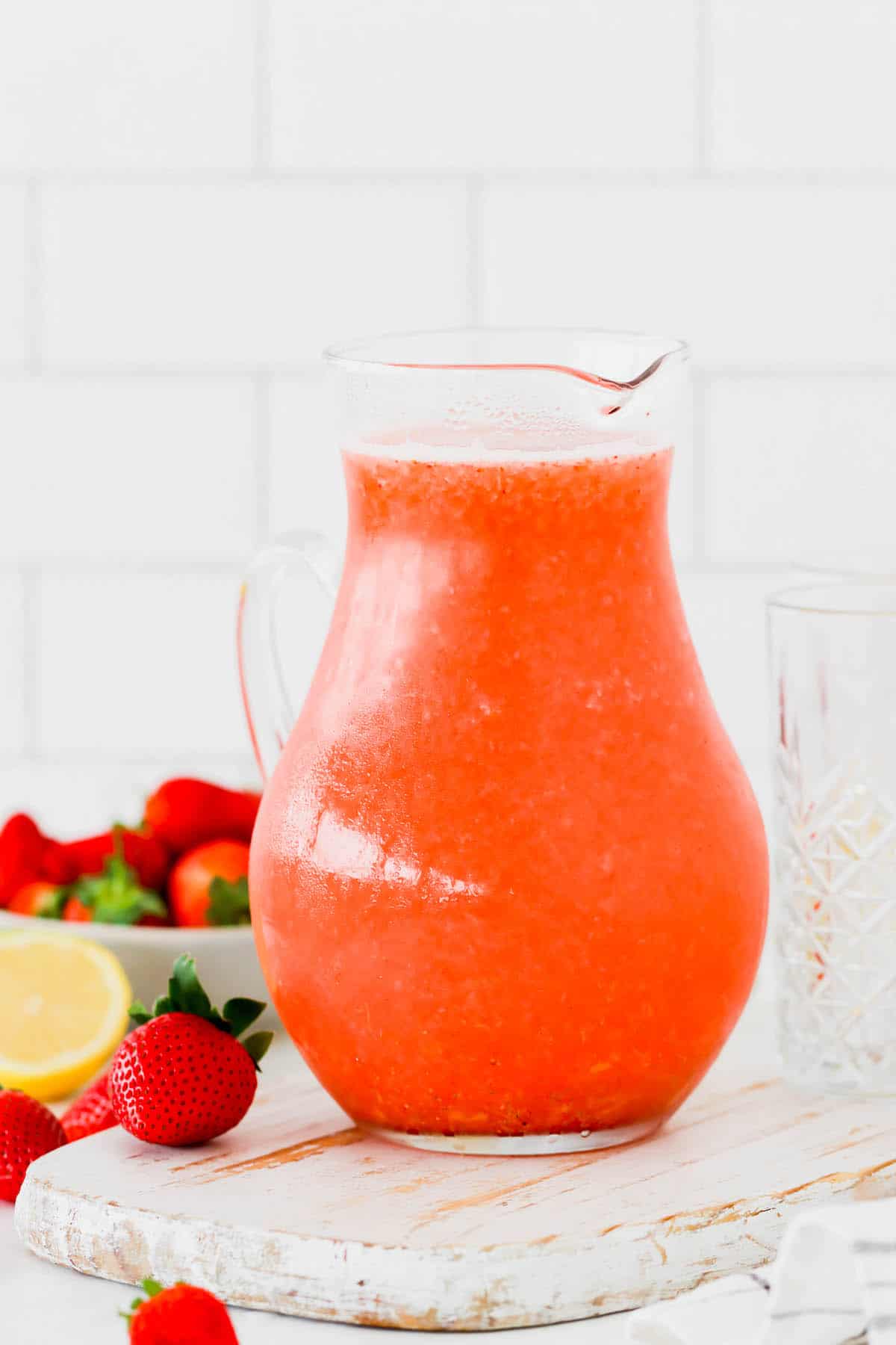 A glass pitcher of homemade strawberry lemonade