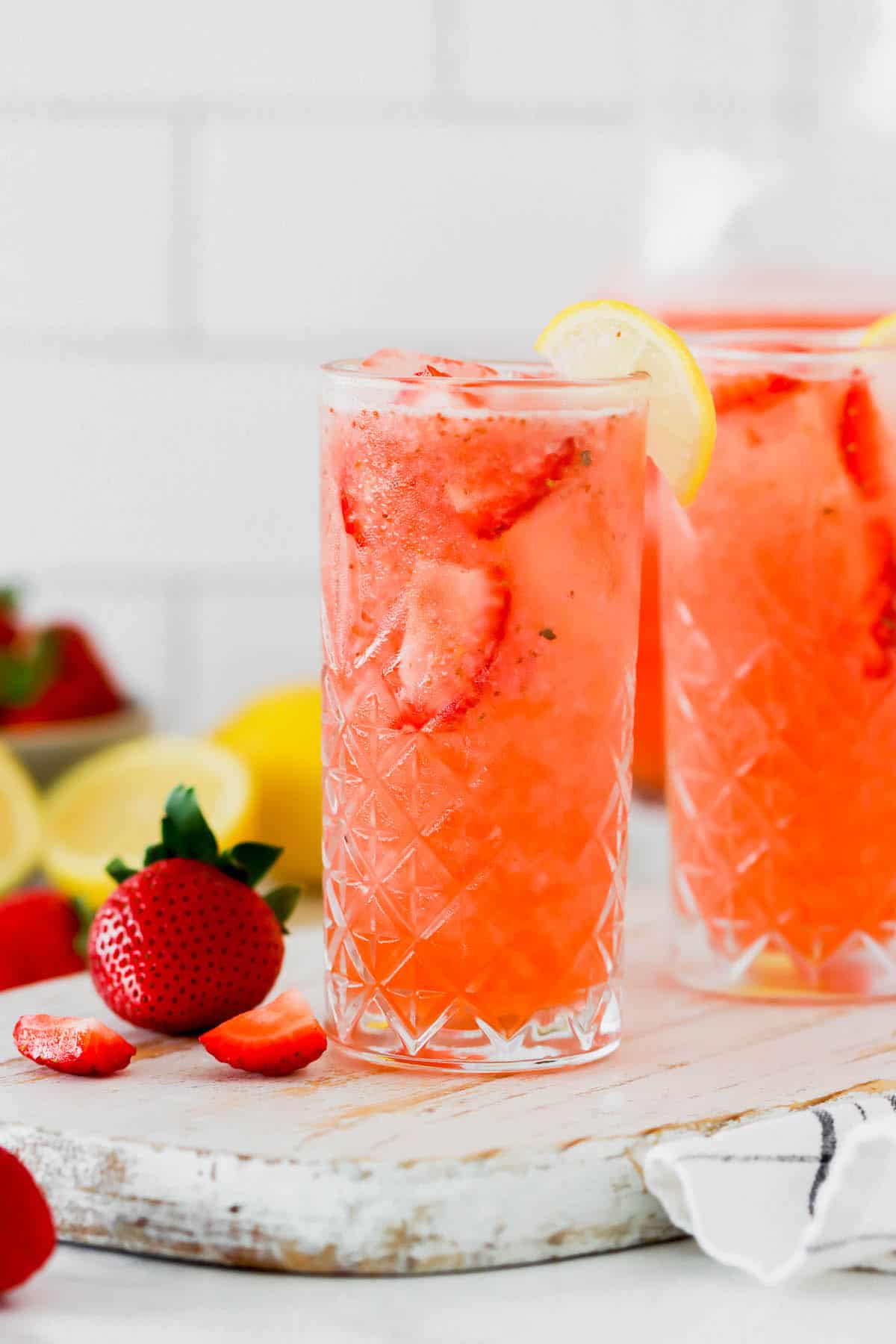 Two glasses of homemade lemonade with strawberries