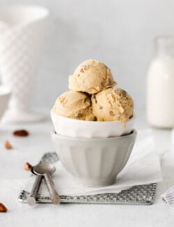 Scoops of butter pecan ice cream in a white dish