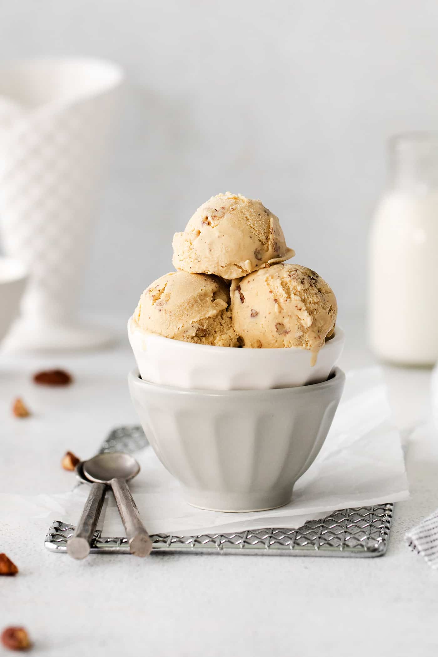 Scoops of butter pecan ice cream in a white dish