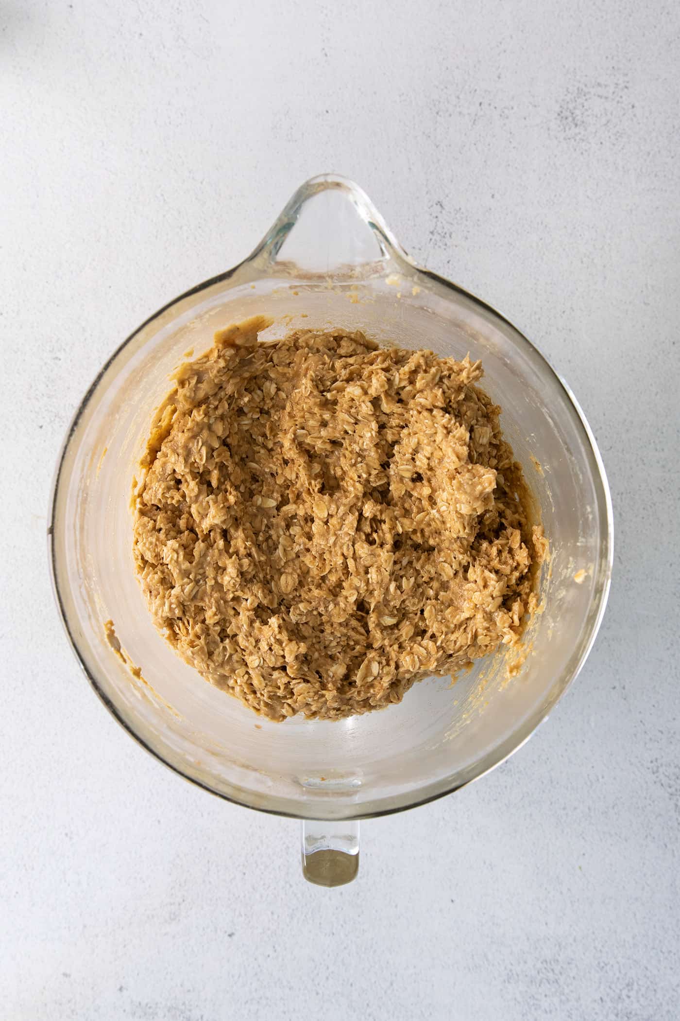 Monster cookie dough in a glass mixing bowl