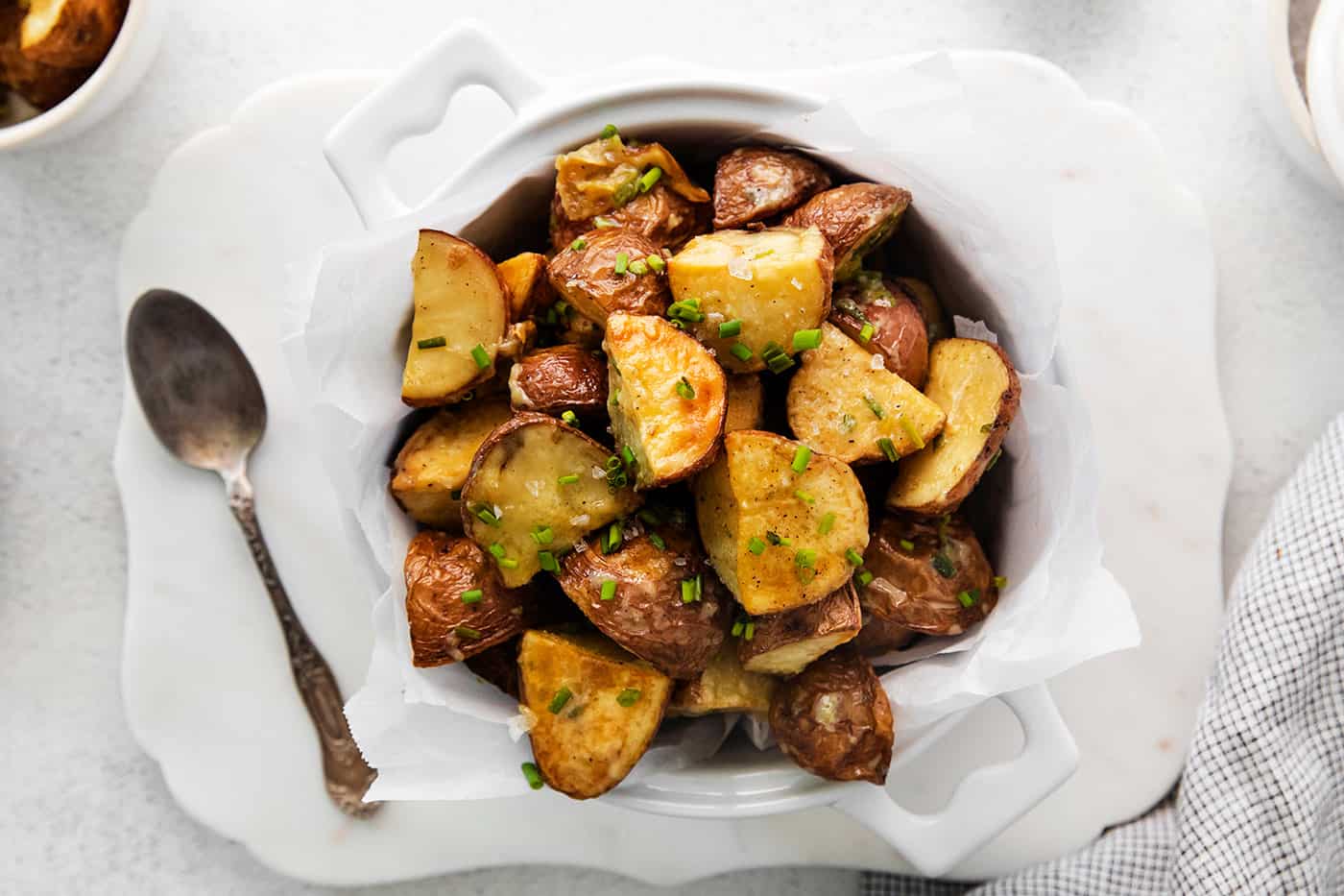 Overhead view of a bowl of garlic roasted new potatoes