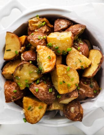 Overhead view of a bowl of garlic roasted new potatoes