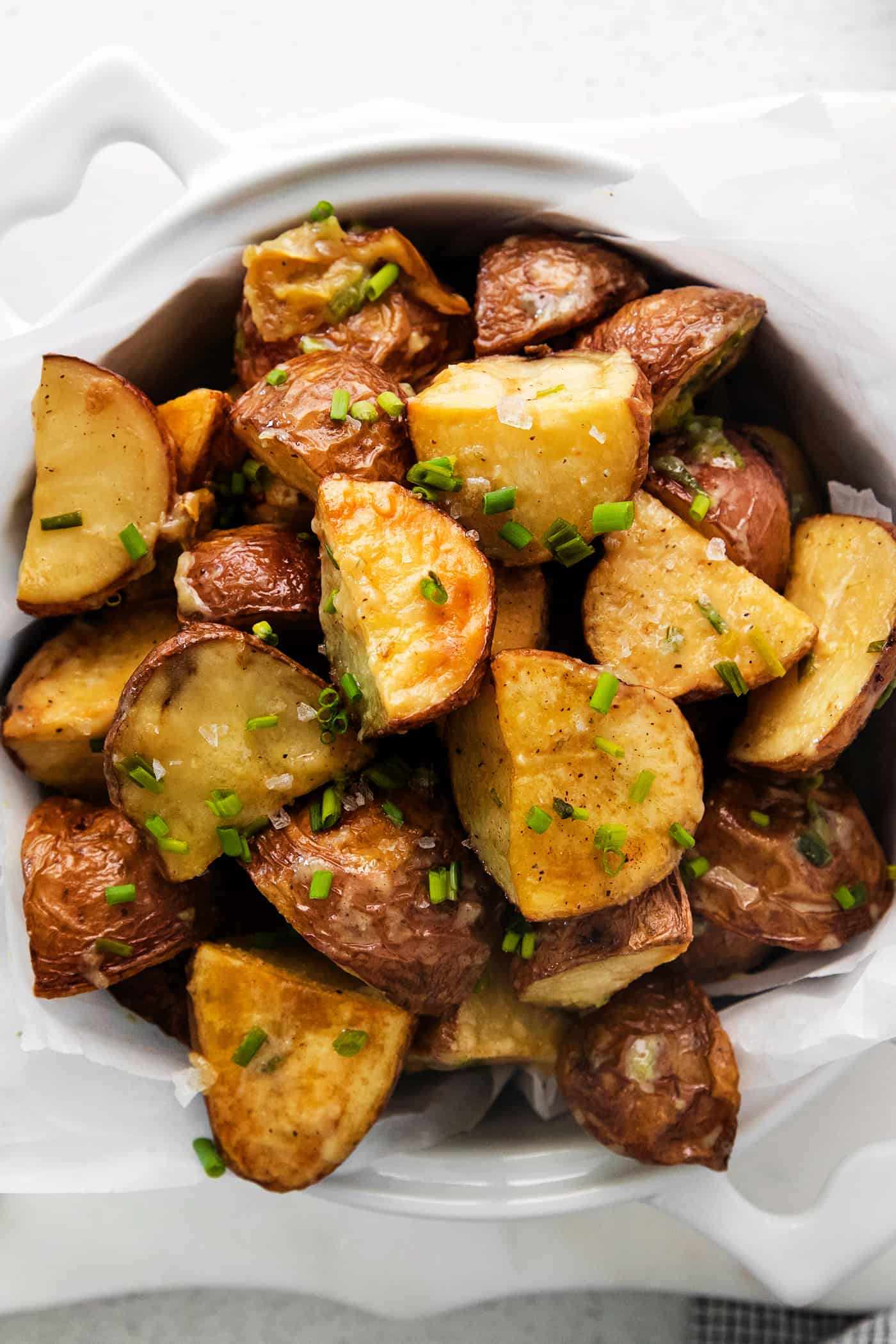 Overhead view of a bowl of garlic roasted new potatoes