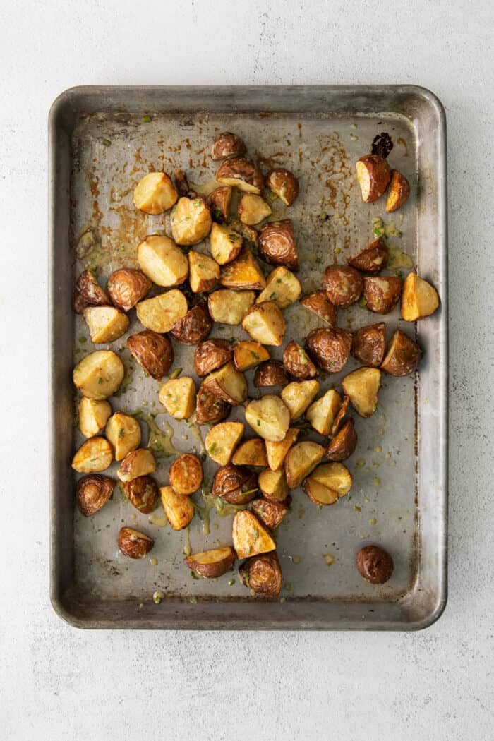 Roasted garlic new potatoes on a baking sheet