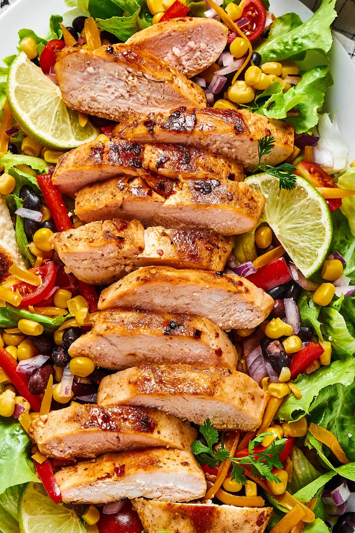 With ingredients like black beans, corn, bell pepper, and tomatoes, this Grilled Chicken Southwest Salad is bursting with flavor. Mexican chicken salad on a platter