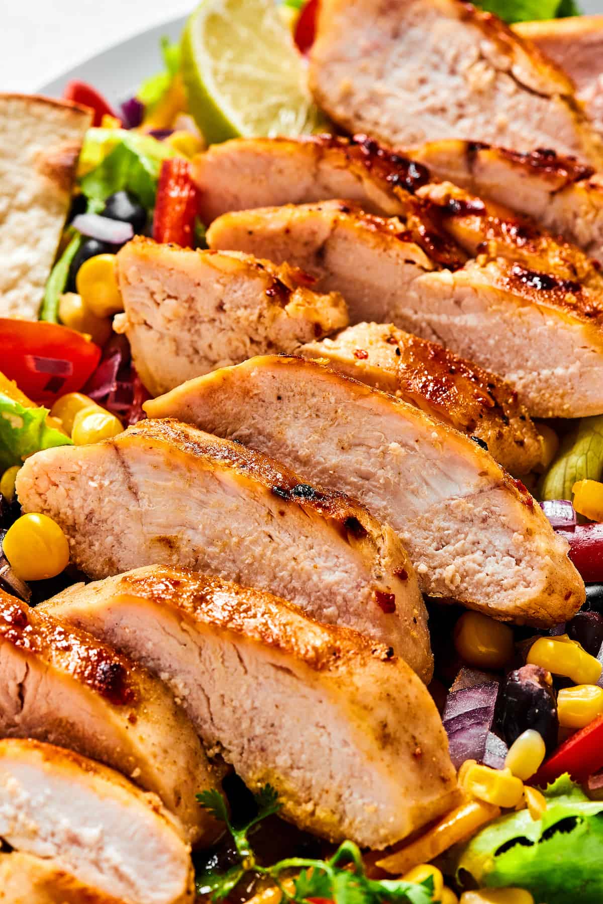Close-up of grilled chicken on salad