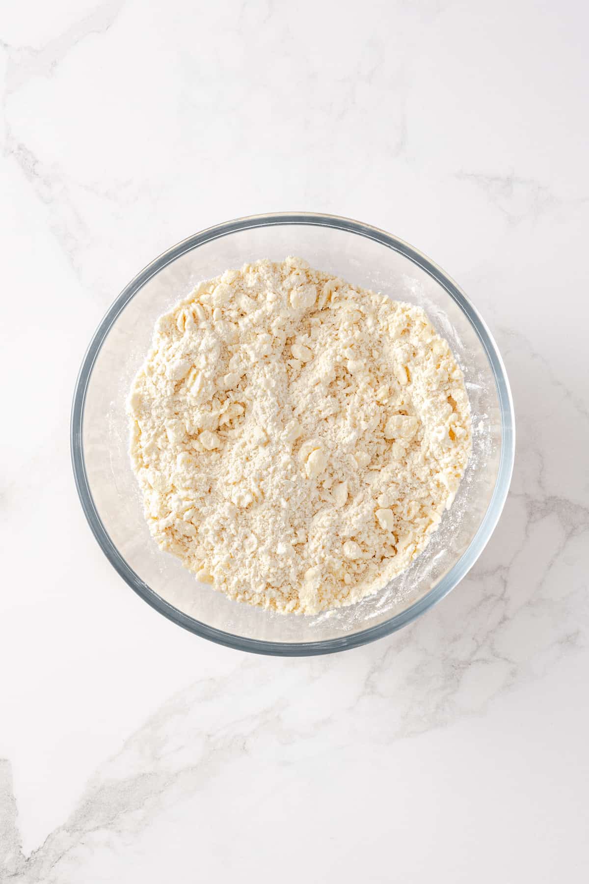 The ingredients for pie dough in a bowl