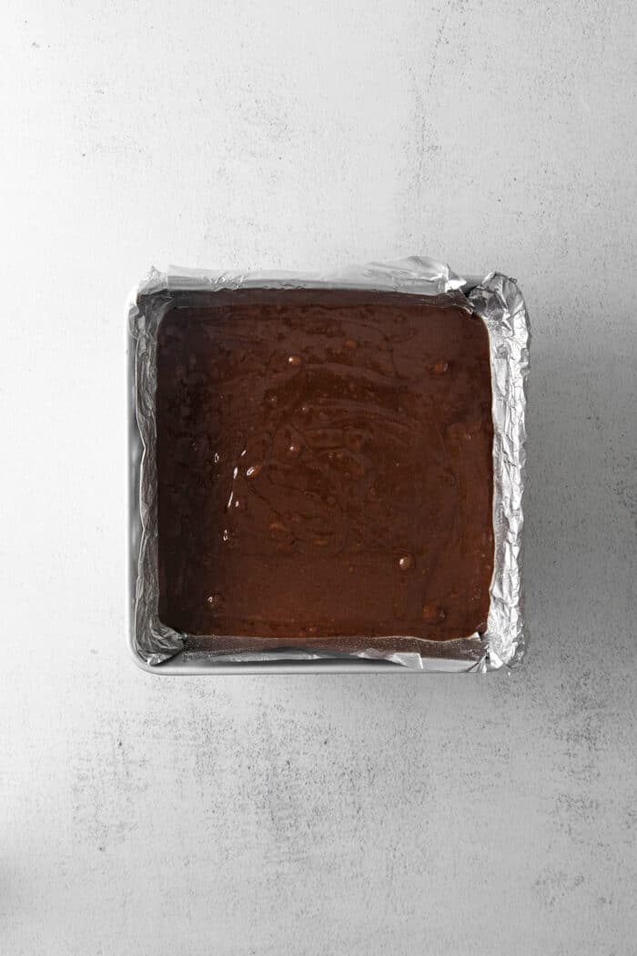 Brownie batter in a square pan