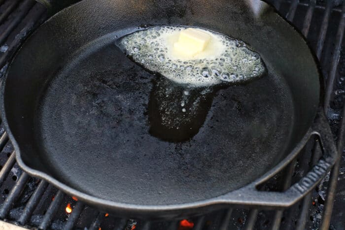 A cast iron skillet with button