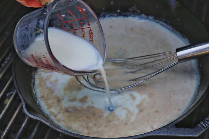 Milk being poured into a flour slurry