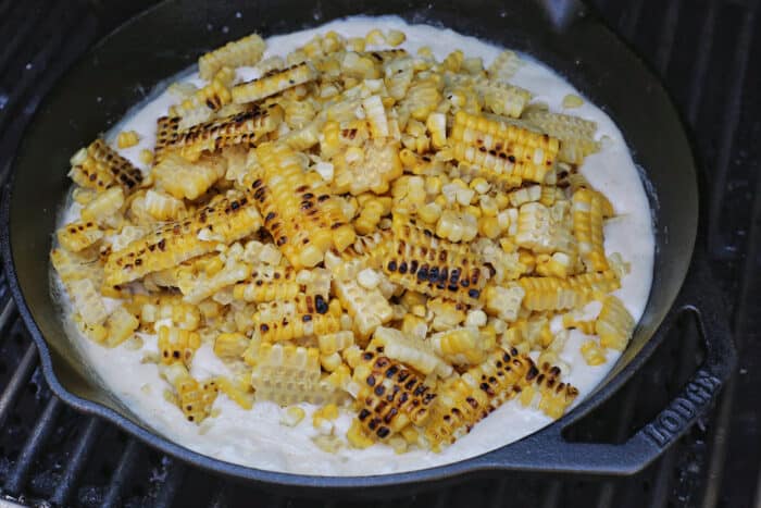 Grilled corn kernels added to a cream cheese and butter mixture