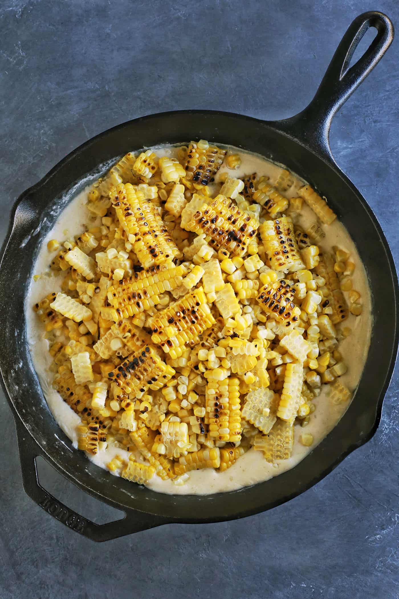 Grilled creamed corn in a cast iron skillet