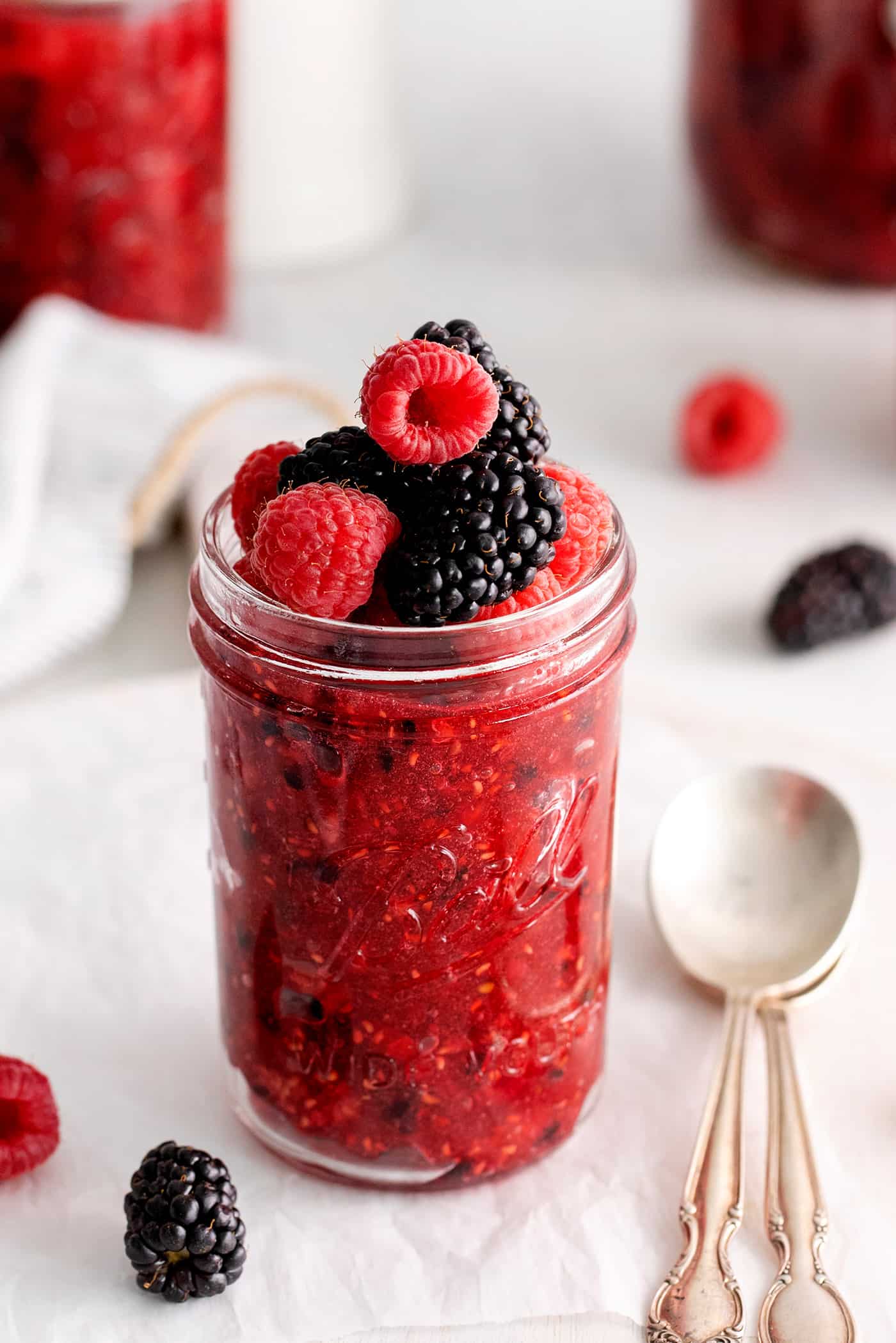 Angled view of a jar of raspberry blackberry freezer jam