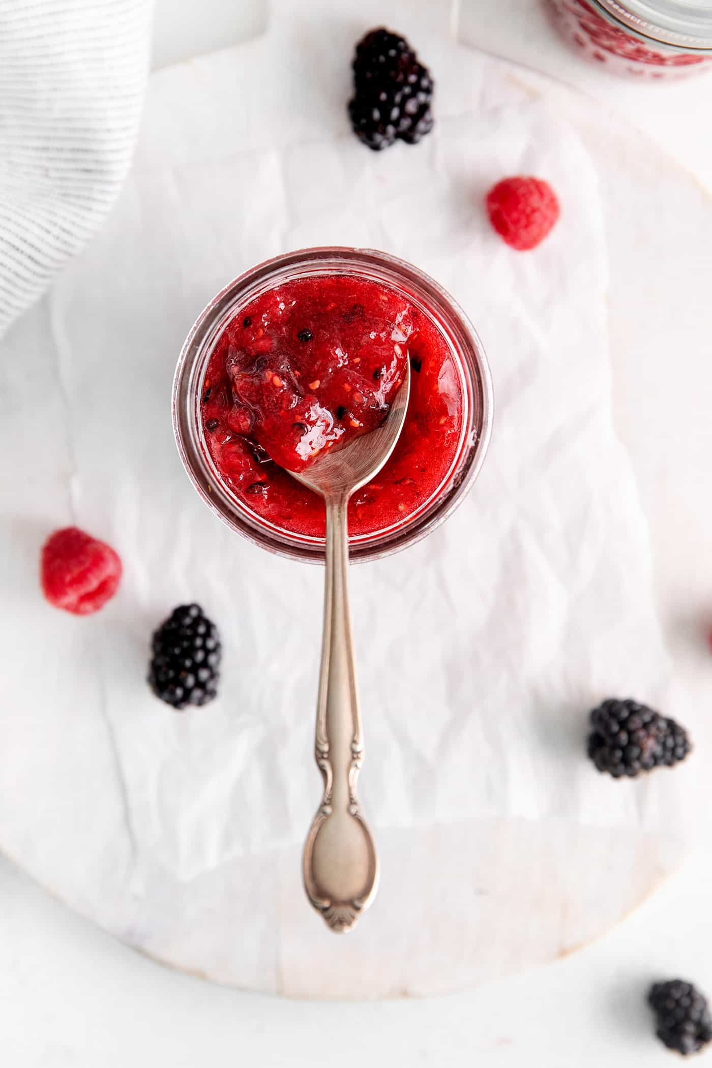 Overhead view of a spoon in a jar of freezer jam