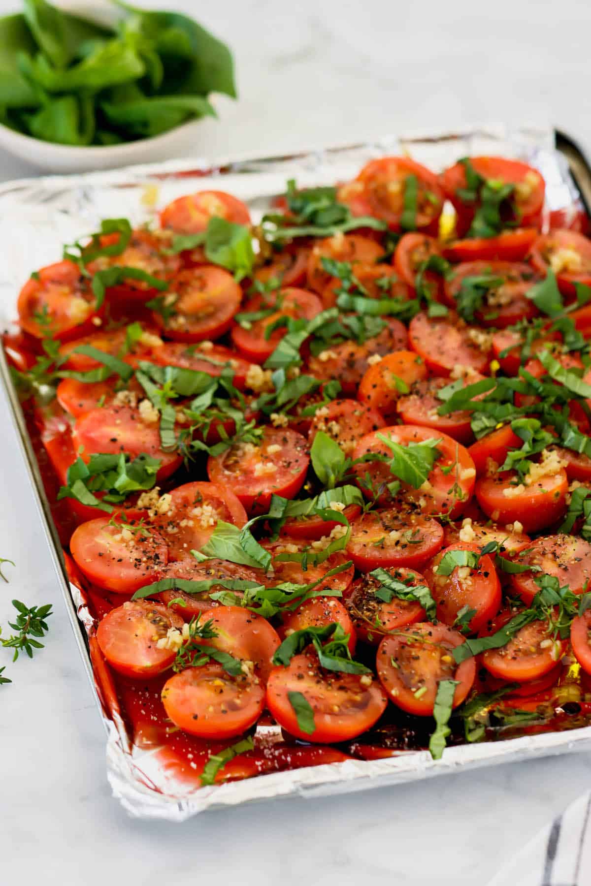 quick roasted tomatoes with basil and thyme on a sheet pan