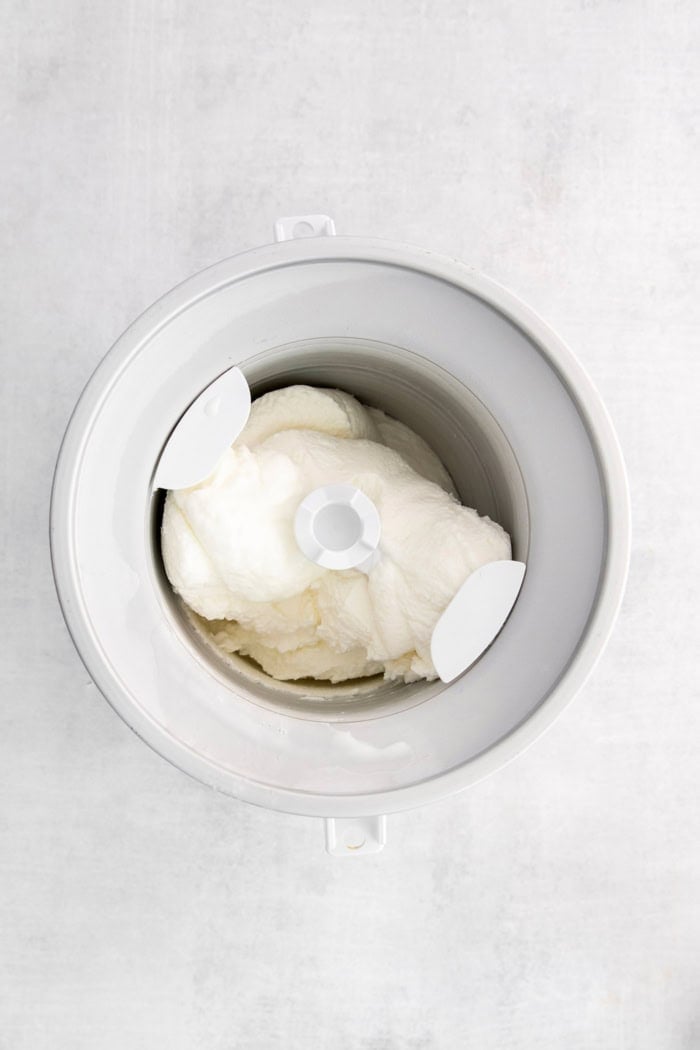 Overhead view of coconut ice cream churning in ice cream maker