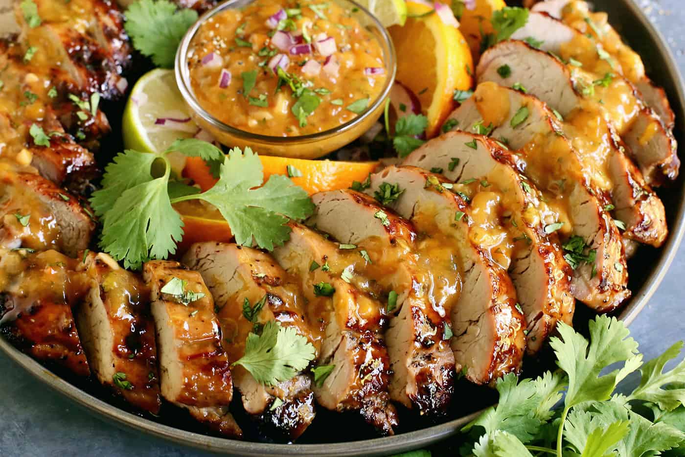 A plate of peach grilled pork tenderloin slices