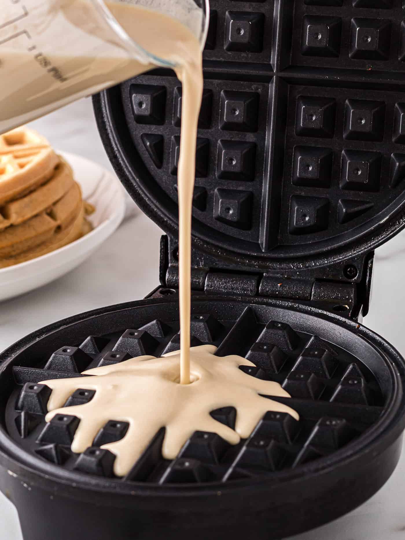 Batter being poured nto a waffle maker