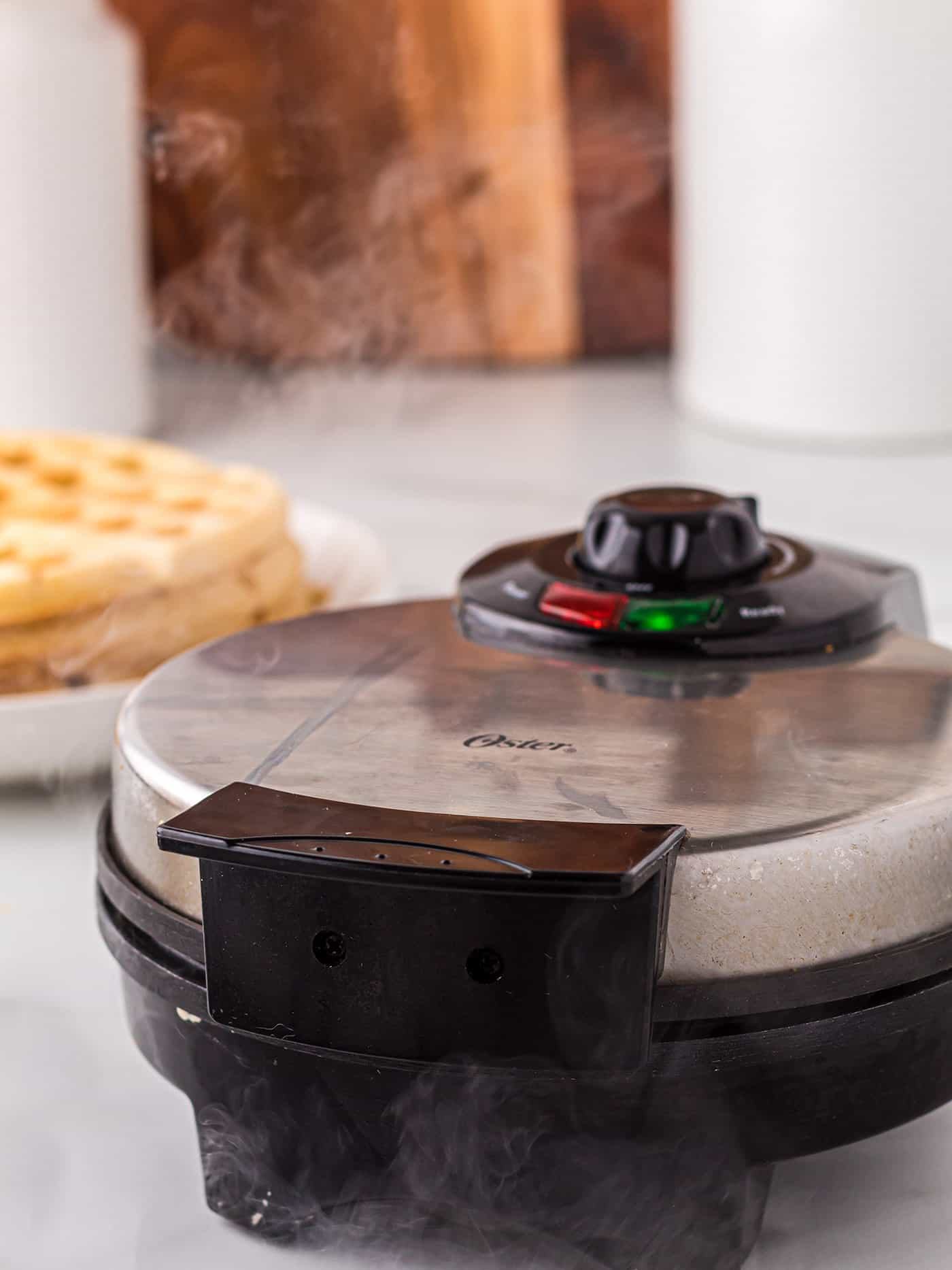 A waffle maker with steam coming out