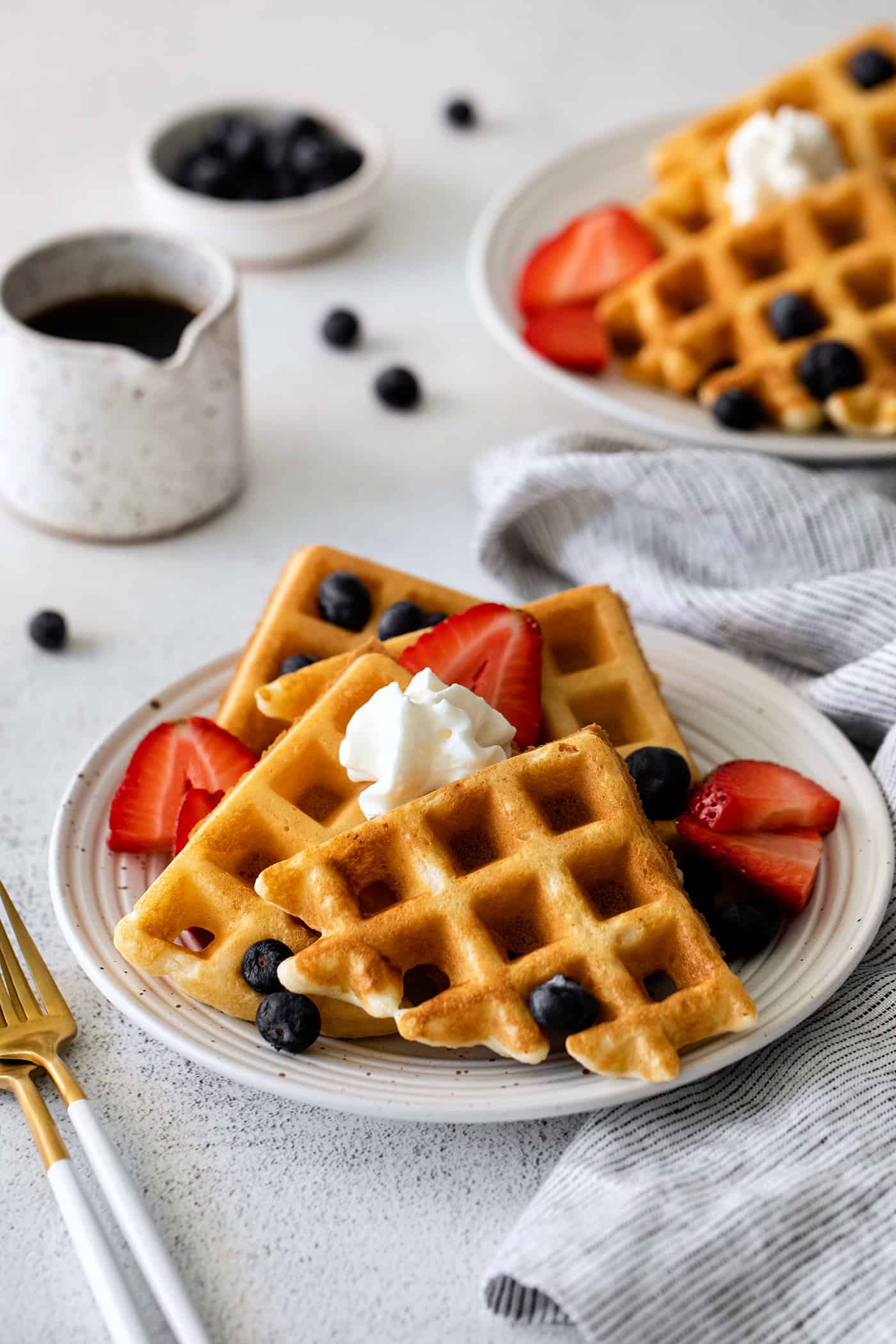 A plate of yeast waffles with berries