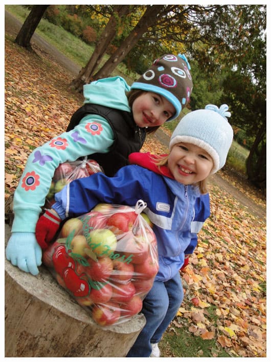 two girls at an apple orchard