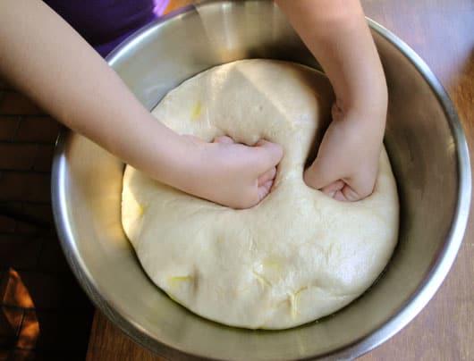 punching pizza dough