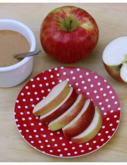 a plate of apple slices and a dish of caramel sauce