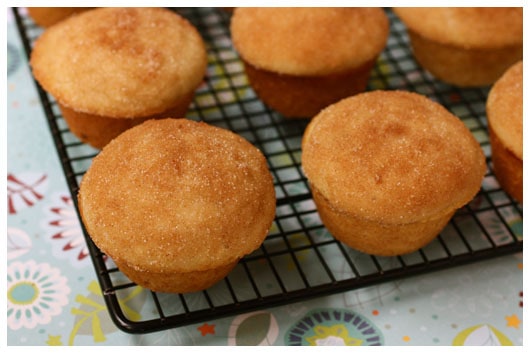 a cooling rack of cinnamon muffins