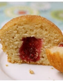 This sliced cinnamon doughnut muffin is easy to much and filled with raspberry jam.
