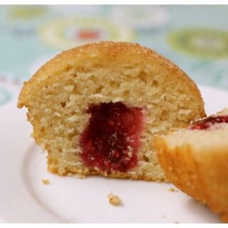 This sliced cinnamon doughnut muffin is easy to much and filled with raspberry jam.