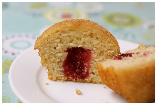 This sliced cinnamon doughnut muffin is easy to much and filled with raspberry jam.