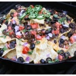 a skillet of nachos on the grill