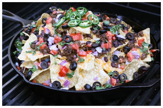 a skillet of nachos on the grill