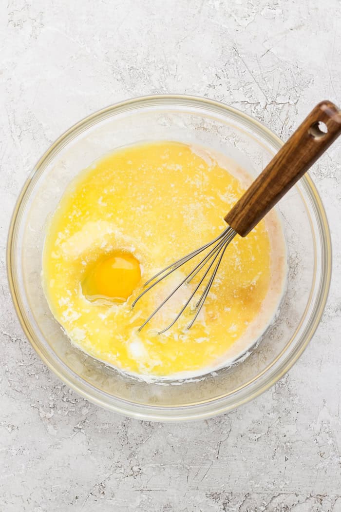 Cinnamon sugar doughnut muffins are easy to make and impossible to resist, with a moist, tender crumb and lots of cozy flavor. Perfection! Overhead view of wet ingredients for doughnut muffins in bowl with whisk