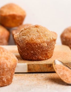 Closeup of cinnamon sugar doughnut muffin on wood board