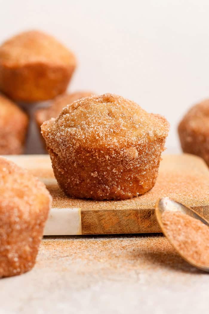 Cinnamon sugar doughnut muffins are easy to make and impossible to resist, with a moist, tender crumb and lots of cozy flavor. Perfection! Closeup of cinnamon sugar doughnut muffin on wood board