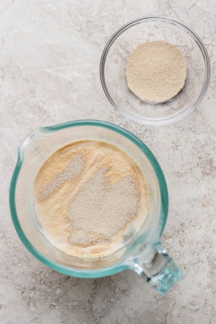 This Grilled Pizza recipe is tested and perfected, with a homemade dough that doesn't fall through the grates. Smoky, crispy, and delicious! Yeast added to warm water in liquid measuring cup.
