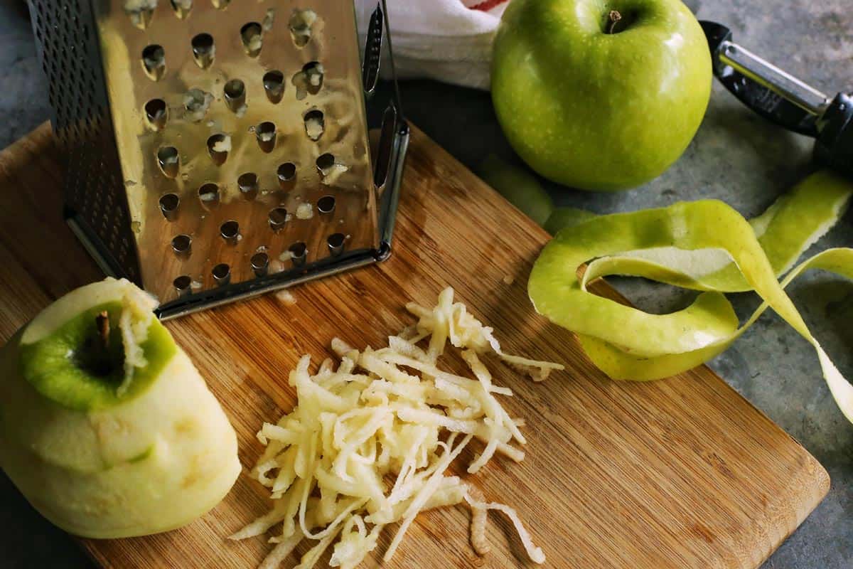 using a box grater to shred fresh apples