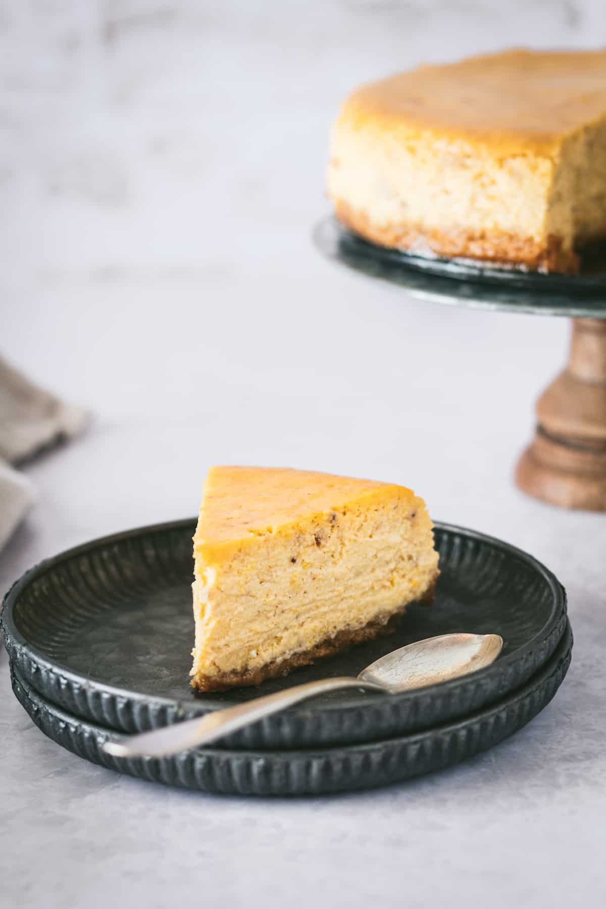 A slice of pumpkin cheesecake on a plate