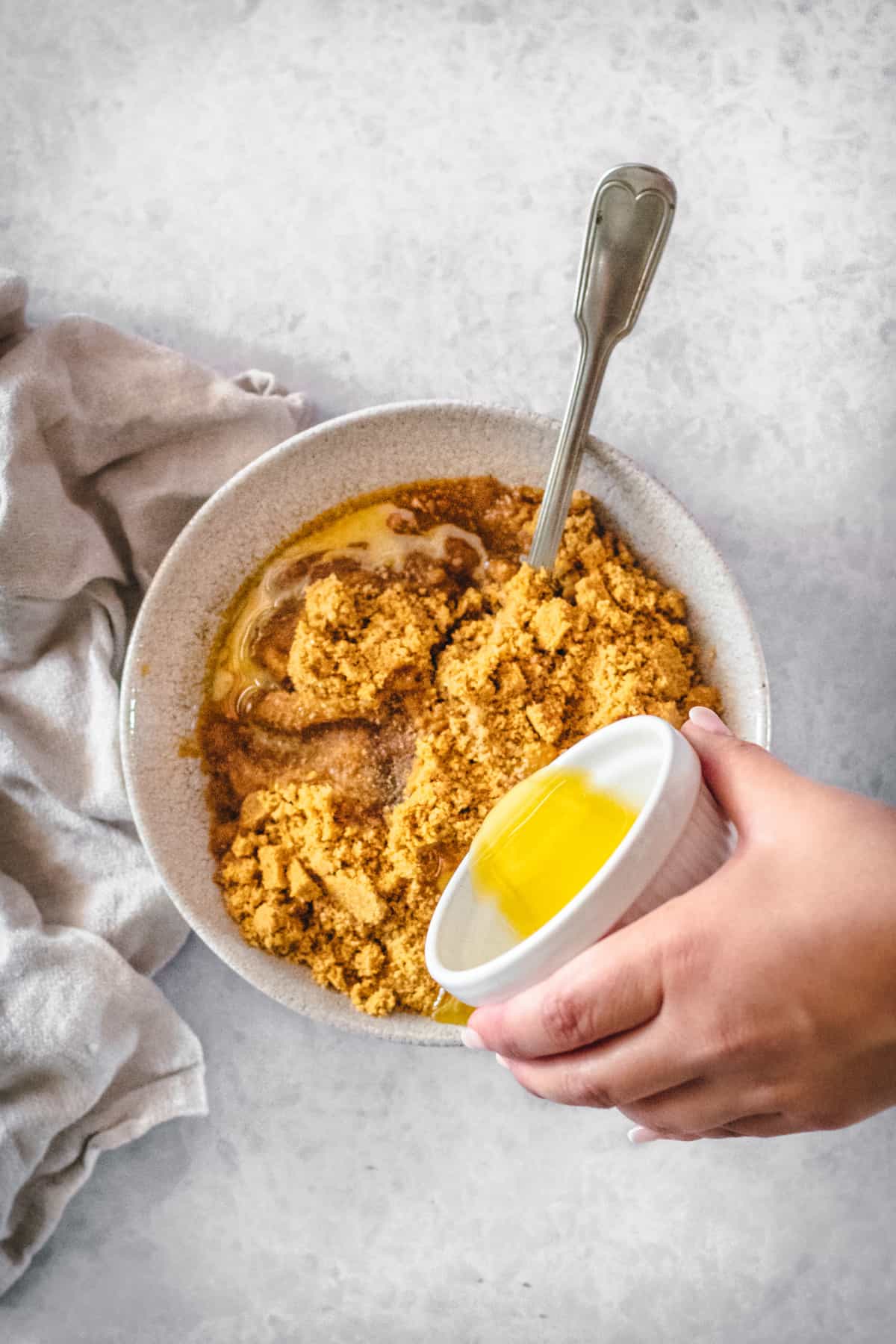 Butter being added to gingersnap crumbs