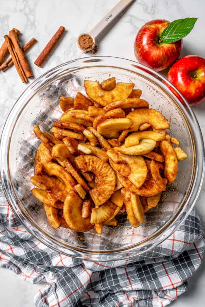 Seasoned apples in glass mixing bowl
