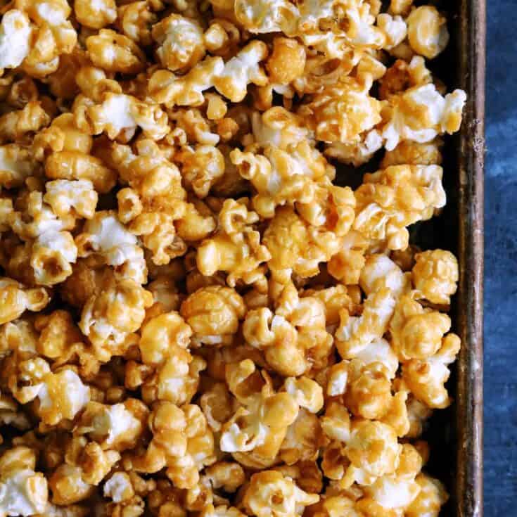Caramel corn on a rimmed baking pan.